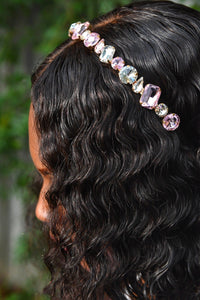 black girl with wavy hair wearing white and pink crystal gemstone headband