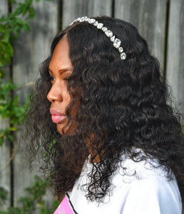 black girl with curly hair wearing a white tshirt and white crystal gemstone headband 
